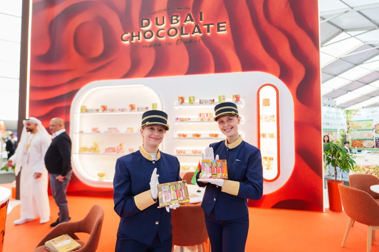 Two members of the exhibition team holding Katrina chocolate selections